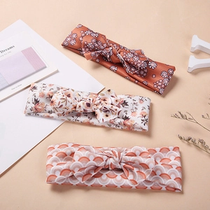 Three soft nylon floral bow headbands for baby girls in brown and pink patterned fabric