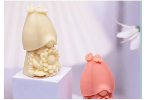Detailed view of beige and pink gnome silicone molds for DIY scented candles and soap making