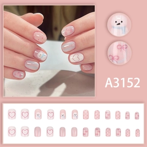 Pink press-on nails with 24 pieces featuring heart, snowman, and bow designs
