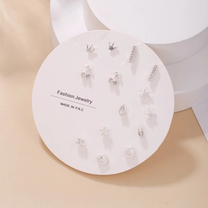 Detailed view of 7-pair silver stud earring set with tassels and sparkling rhinestones