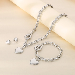 Silver stainless steel heart jewelry set featuring heart pendants and OT toggle clasps