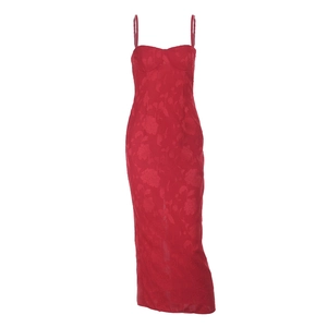 Macro view of red jacquard fabric showing intricate floral texture on a backless dress