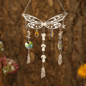 Detailed macro view of silver metal butterfly suncatcher with crystal prisms and mushroom beads