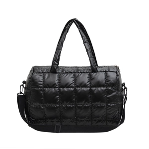 Quilted puffer tote bag in glossy black fabric with adjustable crossbody shoulder strap