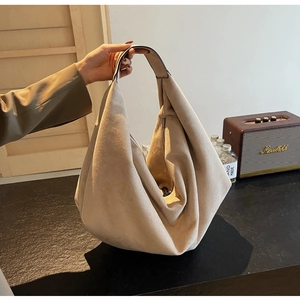 Detail view of khaki faux suede hobo bag showing large capacity and soft silhouette