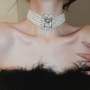 Detail of multi-layer pearl necklace with a large square rhinestone centerpiece for women