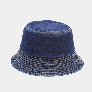 Detailed view of dark blue denim bucket hat with decorative yellow stitching detail