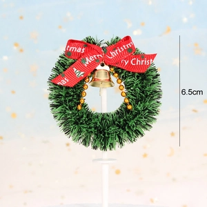 Detailed view of 6.5cm mini Christmas wreath with gold bells and Merry Christmas ribbon