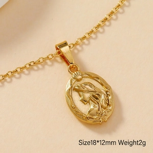Macro detail of oval gold leaf heart pendant with vintage relief portrait 18x12mm