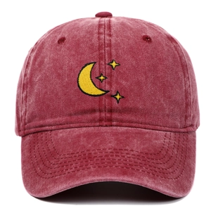 Close-up of yellow moon and star embroidery on vintage washed red cotton baseball cap