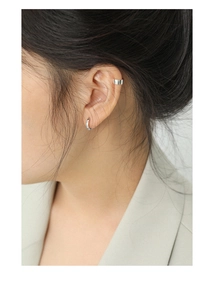 Close-up of elegant S925 sterling silver hoop earrings and wide ear cuff on a model