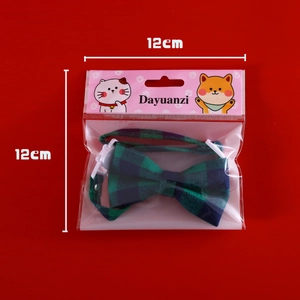 Blue-green plaid pet collar with bow tie and buckle detail in 12x12cm packaging
