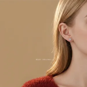 Elegant S925 sterling silver snowflake stud earrings featuring a brilliant center stone