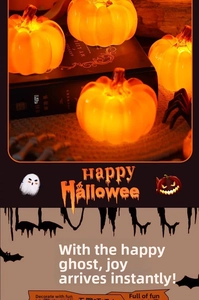 Detail of glowing LED pumpkin lamp with warm light and festive decorations for Halloween table