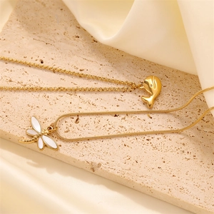 Elegant gold whale and dragonfly necklaces with mother of pearl and crystal charms