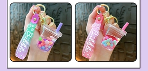 Detail of creative bubble tea cup keychain with liquid quicksand and colorful beads