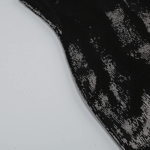Detailed macro view of black fabric with shimmering silver sequins and reflective texture