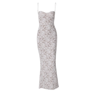Detail of delicate white lace fabric and intricate stitching on a slim-fit maxi dress