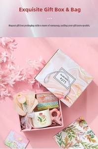 Pink gift box set with tulip pattern ceramic mug, decorative flowers, and greeting card