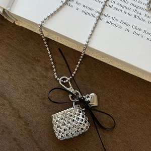 Silver woven bag pendant necklace with a black bow and small heart charm on a bead chain
