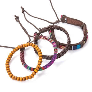 Set of four minimalist braided leather, wooden beads, and ethnic fabric bracelets