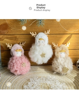 Detail view of plush Christmas angel ornaments with reindeer antlers and golden sequins