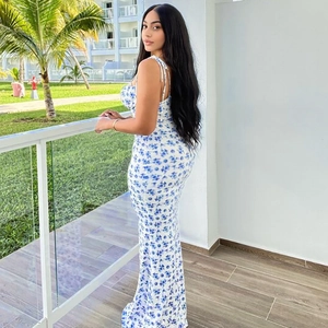 Close-up of a white and blue floral spaghetti strap maxi dress for summer vacations