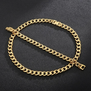 Detailed close-up of golden Cuban link chain with square buckle on dark textured surface