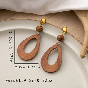 Detail showing dimensions of vintage drop-shaped wood earrings with gold stud accents