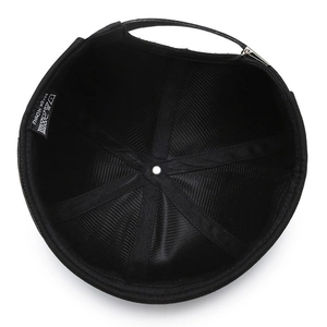 Interior view of black brimless docker hat showing cotton twill fabric and metal buckle