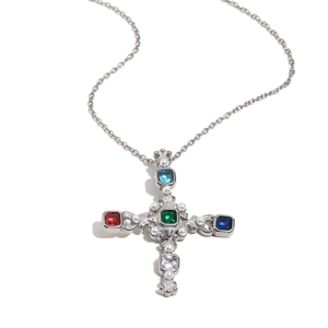 Silver vintage cross necklace with colorful gemstones and pearls on white background