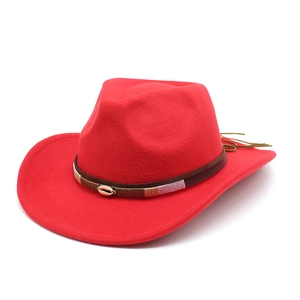 Detailed view of red wool felt cowboy hat with ethnic embroidered band and gold shell