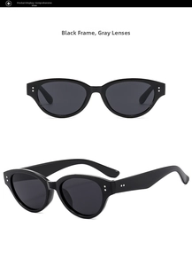 Close-up of cat-eye sunglasses in black frame with gray lenses and silver dot accents
