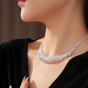 Close-up of sparkling multi-row rhinestone tassel necklace in a luxury V-shaped design