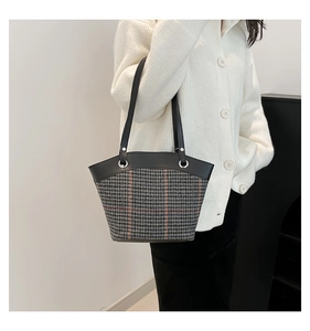 French style bucket bag featuring grey-black houndstooth pattern and black leather trim