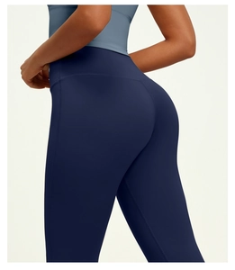 Detail view showing high waist fit and shaping fabric of dark blue yoga leggings