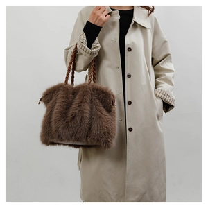 Detail of plush brown faux fur tote bag featuring unique braided rope handles and soft texture