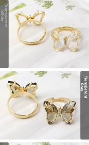 Close-up of adjustable butterfly rings in transparent white and gray crystal designs