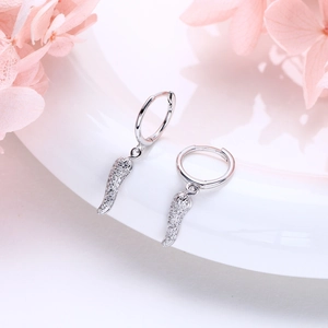 Close-up of S925 silver hoop earrings featuring wing pendants with sparkling white zircons