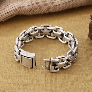 Macro detail of vintage silver stainless steel thick chain bracelet with square buckle