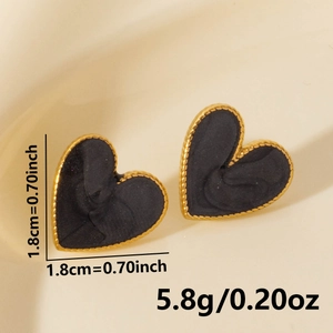 Detail showing vintage golden rope edges and black spiral texture on heart earrings