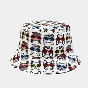 Detail of white bucket hat featuring cute French Bulldogs with colorful heart sunglasses