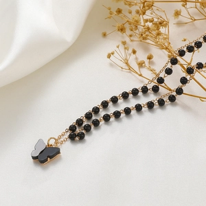 Gothic double-layered butterfly pendant necklace with black beads on white silk