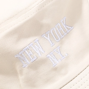 Macro detail of NEW YORK embroidery on premium cream twill cotton bucket hat fabric