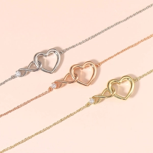 Three minimalist heart and infinity symbol bracelets in gold, rose gold, and silver finishes
