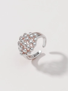 Macro view of gold-plated brass bead ring showing intricate vintage hollow texture details