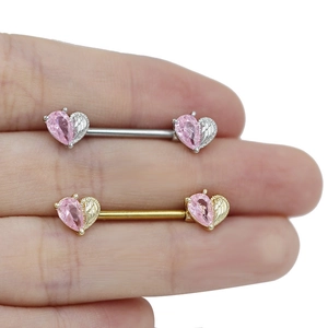 Macro view of heart-shaped pink zircon nipple rings with feather wing design details