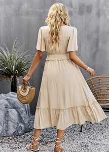 Detail of elegant beige V-neck dress with elastic waist and ruffled short sleeves