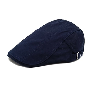 Detail view of navy blue newsboy cap featuring adjustable metal buckles and reinforced stitching