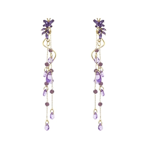 Detail of long purple crystal butterfly earrings with golden tassel chains and teardrop beads